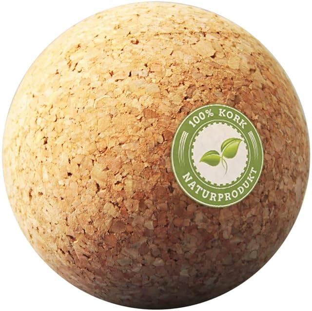 A single coarse-grained cork ball filling the frame, a green 100% Kork Naturprodukt roundel on its side
